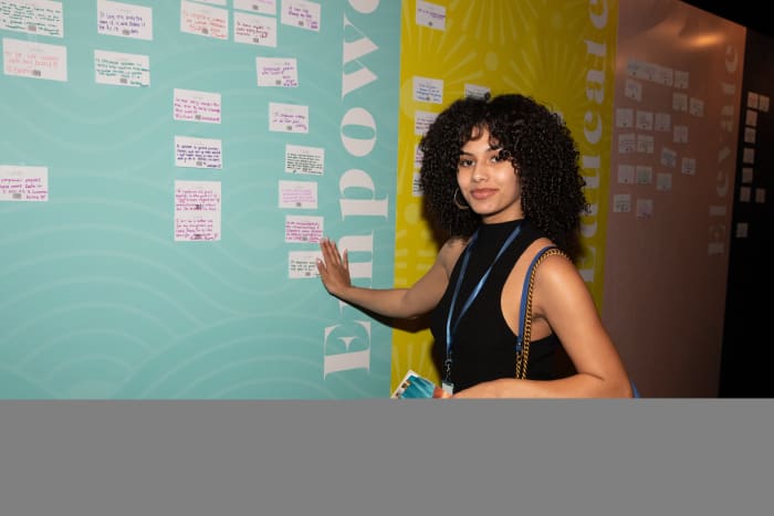 A TSN member stands next to her pledge at the event.